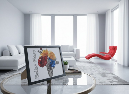 Modern living room with a red chair, white sofa, and a framed picture of Belles Fleurs (flowers) on a glass table.